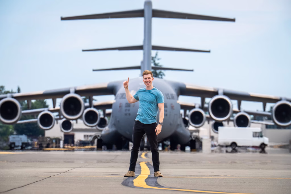 A picture of Sam Eckholm pointing at a plane
