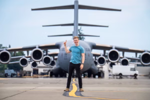 A picture of Sam Eckholm pointing at a plane